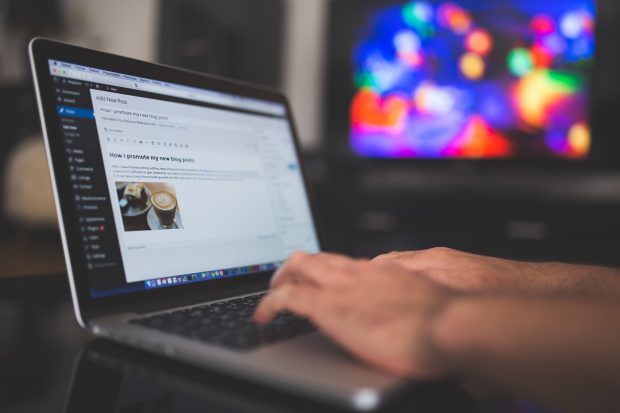 Person typing a blog post for a Wordpress site