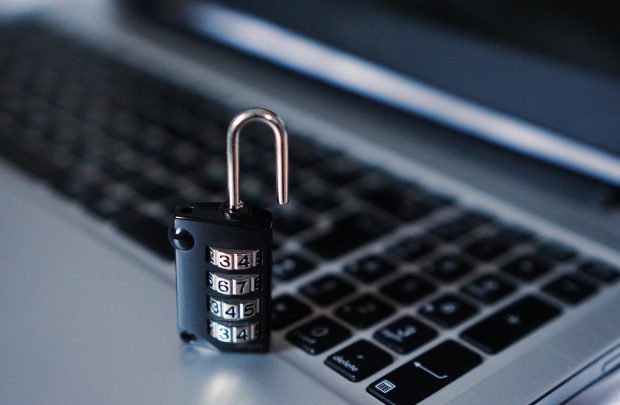 padlock sitting on top of a laptop